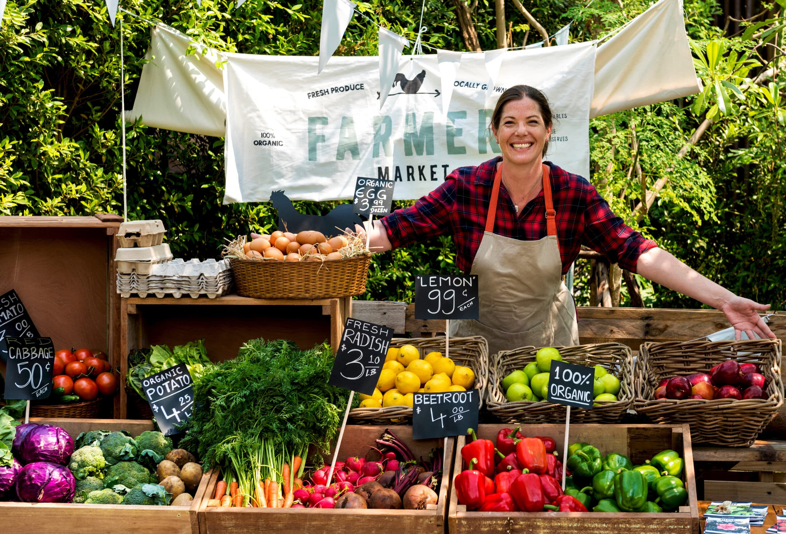 Greengrocer selling organic fresh agricultural product at farmer's market